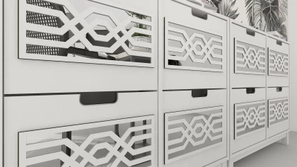 CNC cut decorations on a drawer front with a mirror background