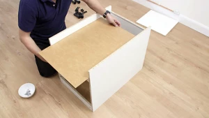 Sliding a base of a drawer into a groove